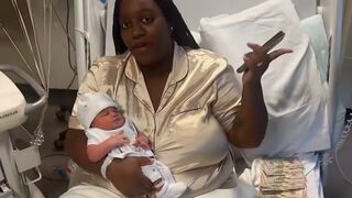 Black mother cover the bed with her newborn in piles of cash and thrown cash into air