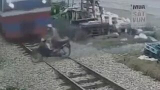 Vietnam: Man Drives onto the Train Tracks without Looking..