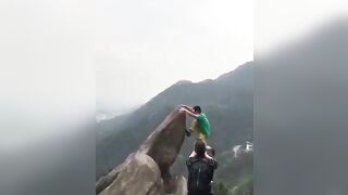 Kid trying to take a Perfect Picture Falls from the Mountain
