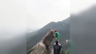 Kid trying to take a Perfect Picture Falls from the Mountain