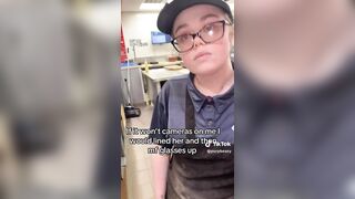 A foul-mouthed black woman berates a white female dominos employees.