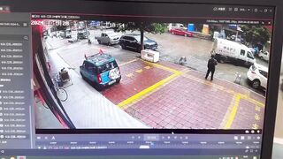 Only in China..Brinks Type Truck somehow Runs Over the Guard who Just got out of the Car