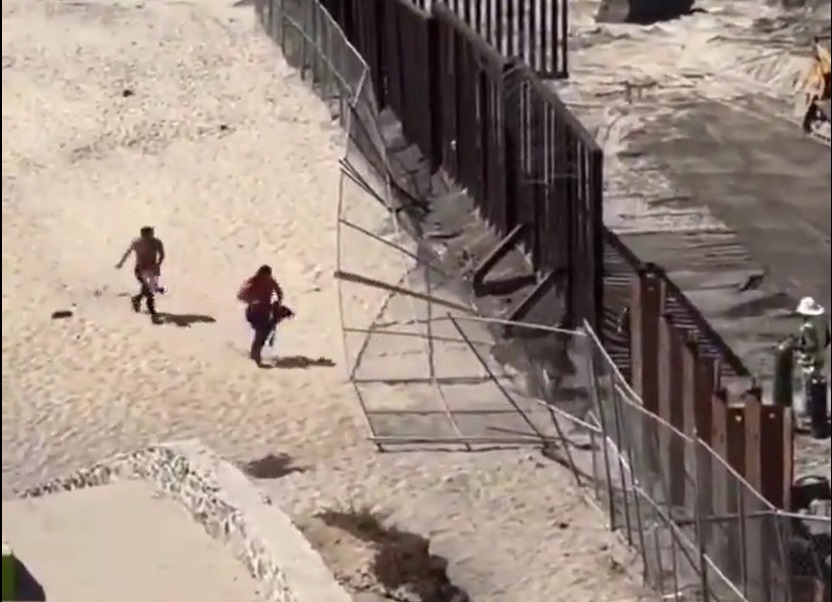 Wide Open! Illegal Immigrants Run through a Hole in the Border Wall