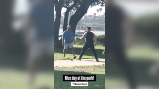 Two men get into a fight then their dogs start fighting