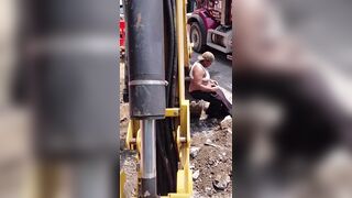 The excavator operator asked her to get away from his machine and she refused