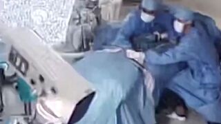 Surgeons cling to a patient during surgery as a powerful 7.1-magnitude earthquake
