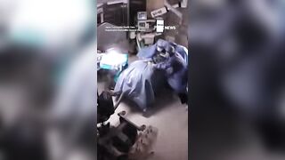 Surgeons cling to a patient during surgery as a powerful 7.1-magnitude earthquake