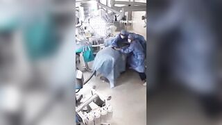 Surgeons cling to a patient during surgery as a powerful 7.1-magnitude earthquake