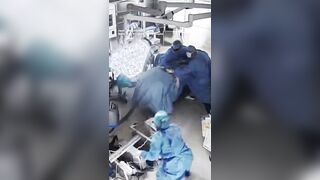 Surgeons cling to a patient during surgery as a powerful 7.1-magnitude earthquake