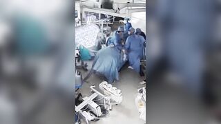 Surgeons cling to a patient during surgery as a powerful 7.1-magnitude earthquake