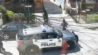 Female officer ran away as a man destroys her car and threw a stone at her