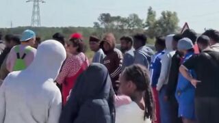 Jewish NGO clowns "entertaining" invaders in Dunkirk waiting to enter the UK.