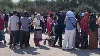 Jewish NGO clowns "entertaining" invaders in Dunkirk waiting to enter the UK.