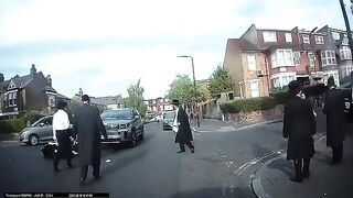 Motorbike collides with a car on a residential street in Stamford Hill
