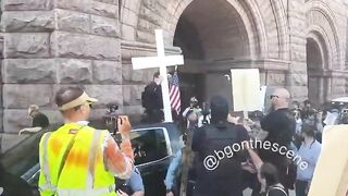 Chaotic scene in Minneapolis as Jake Lang rides in the bed of a pickup ttuck