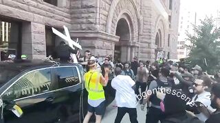 Chaotic scene in Minneapolis as Jake Lang rides in the bed of a pickup ttuck