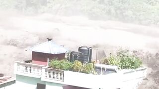 Terrifying footage shows a flash flood sweeping through the Nepal–Tibet border, trapping people on rooftops and balconies.
