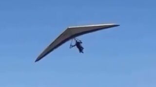 A hang glider pilot was injured after losing control and crashing onto a parked car