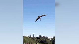 A hang glider pilot was injured after losing control and crashing onto a parked car