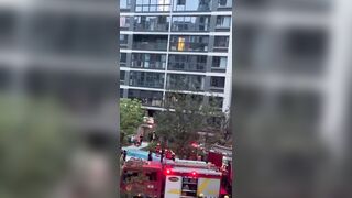 China: Man stuck in Fire Falls from Balcony and Hits a Rescuer on the Way Down (Watch Aftermath)