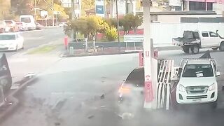 Insane Moment Out-Of-Control Car Narrowly Misses Pedestrian Before Petrol Station Crash