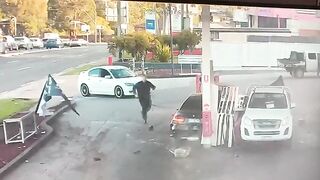 Insane Moment Out-Of-Control Car Narrowly Misses Pedestrian Before Petrol Station Crash