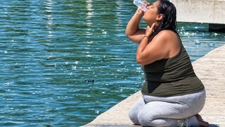 Woman in MacArthur Park chugs filthy fountain water and douses herself with it. This