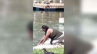 Woman in MacArthur Park chugs filthy fountain water and douses herself with it. This