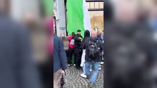 A huge Palestinian flag was unfurled from a building above an H&M store in Amsterdam during a pro-Israel demonstration