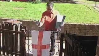 DISGUSTING: Foreign Royal Mail worker SPITS on England flag