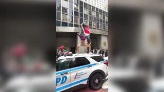 Transgender man stands on top of an NYPD car and screams “Free Palestine”