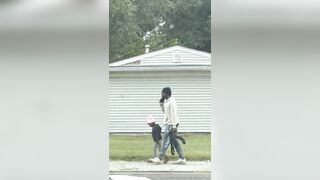 A father was filmed walking his little daughter to school... …armed with a AK-47