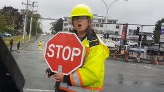 A traffic director walks into a vehicle and acts like she got hit