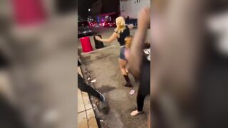 group of Black women BRUTALLY beating a White woman in the middle of the street.