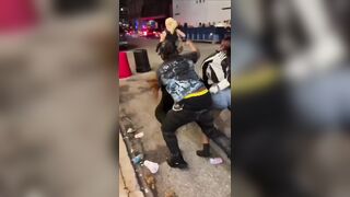 group of Black women BRUTALLY beating a White woman in the middle of the street.