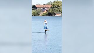 Olympian Alina Kornelli practicing on a pumpfoil in a traditional Bavarian dirndl