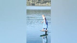 Olympian Alina Kornelli practicing on a pumpfoil in a traditional Bavarian dirndl