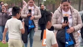 Smiling Latina mother films her son at an anti-ICE protest as he chants “Fuck ICE "