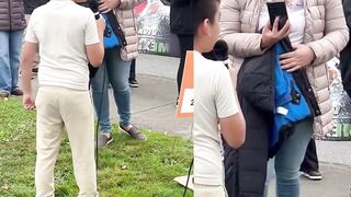 Smiling Latina mother films her son at an anti-ICE protest as he chants “Fuck ICE "