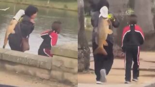 Asians stealing a giant carp from a pond in Sydney's Centennial Park