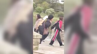 Asians stealing a giant carp from a pond in Sydney's Centennial Park