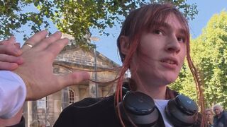 Transgender lunatic threatens man holding a sign that reads “Trans women are men.”