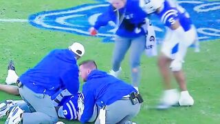 A Duke football player SWATS at a female medical staff worker on the field