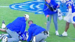 A Duke football player SWATS at a female medical staff worker on the field