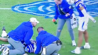 A Duke football player SWATS at a female medical staff worker on the field