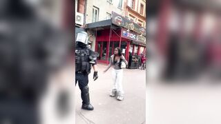 French police struck a woman who appears to have not done anything amid protests