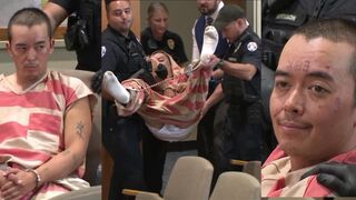 Man CARRIED into court after allegedly murdering his father and stepmother.