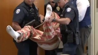 Kid accused of Killing his Parents carried like a baby into courtrom