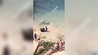 Topless Possessed Woman in Ibiza Beach Barks at Cops among Other Crazy Things