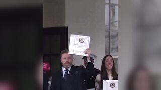 group of Journalists leave the White House holding Phase 1 of the Epstein file